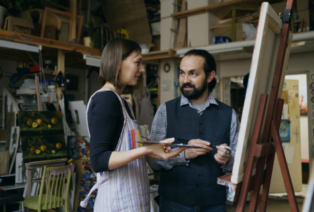 Artist mentor and student reviewing work in a studio for a Glasgow School of Art BA Fine Art portfolio application.