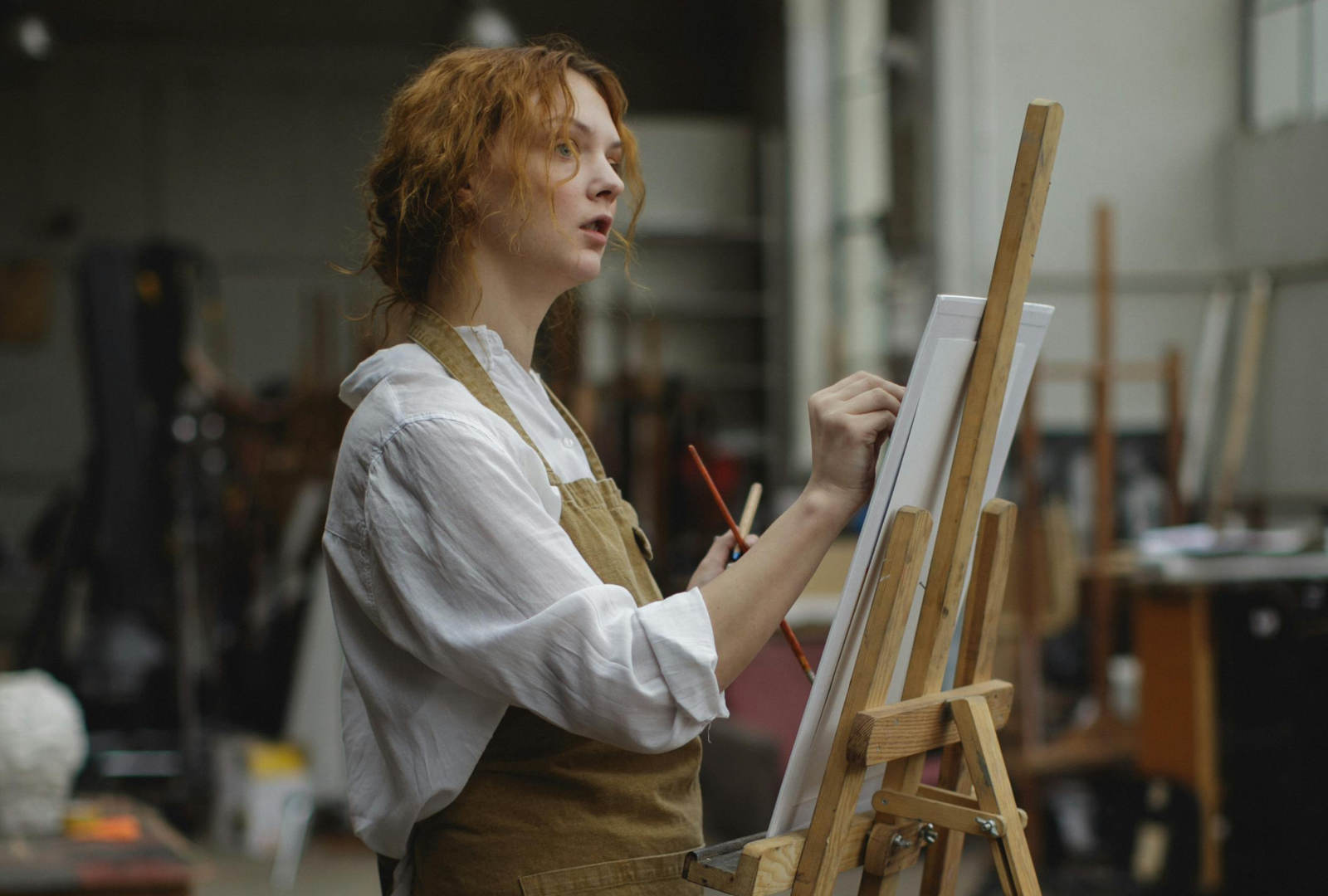 Artist preparing a painting portfolio in a studio for Royal Academy Schools postgraduate application.