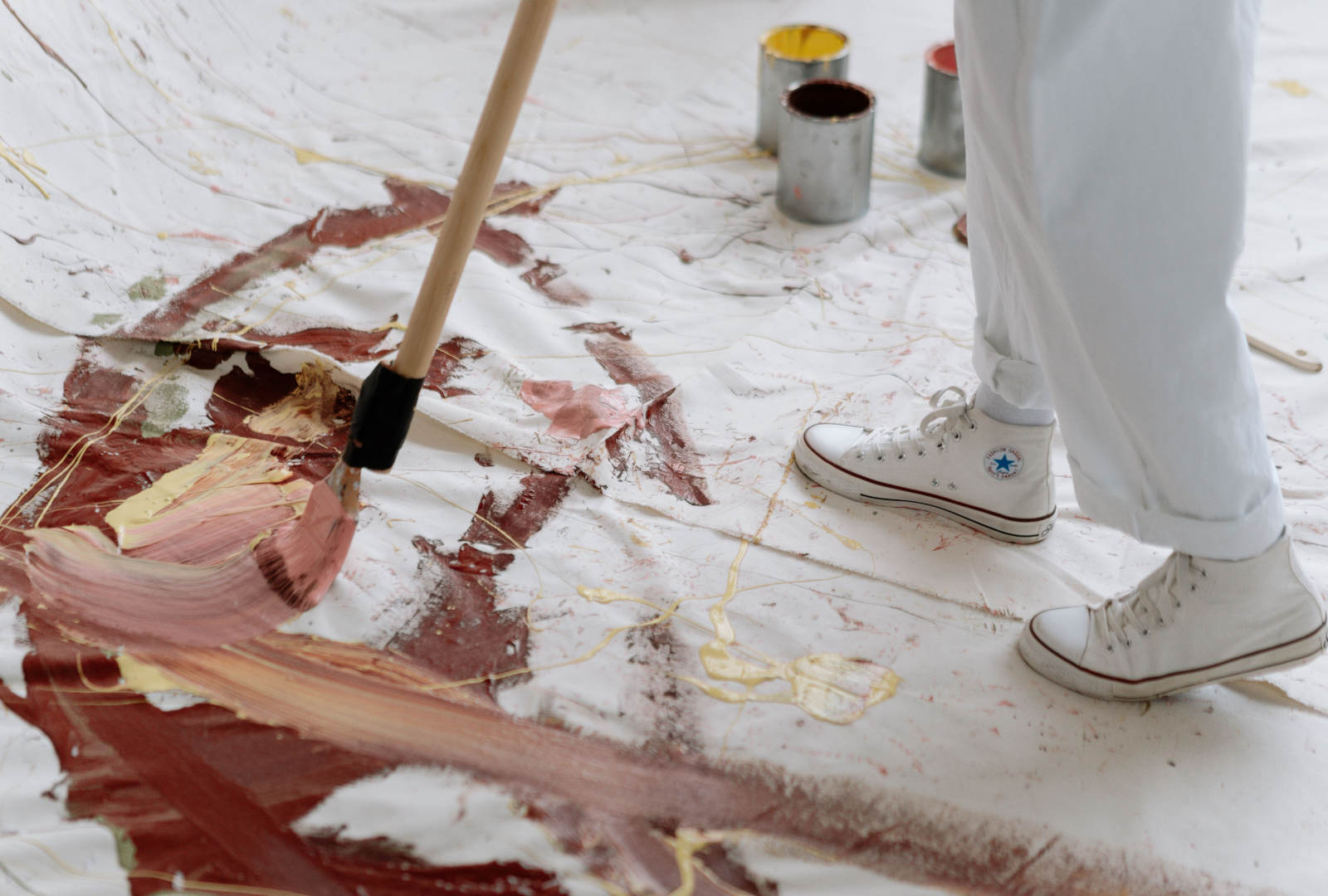 Applicant painting directly on studio floor during fine art portfolio development for Slade BA/BFA Fine Art.