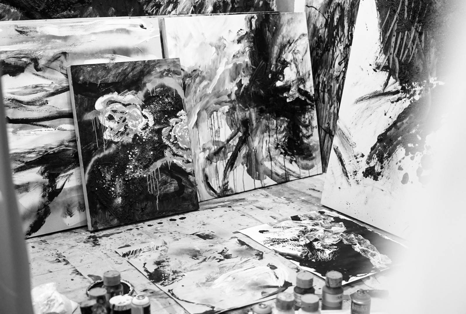 Black and white painting studio with expressive abstract canvases, suitable for a UdK Berlin Fine Arts portfolio article.