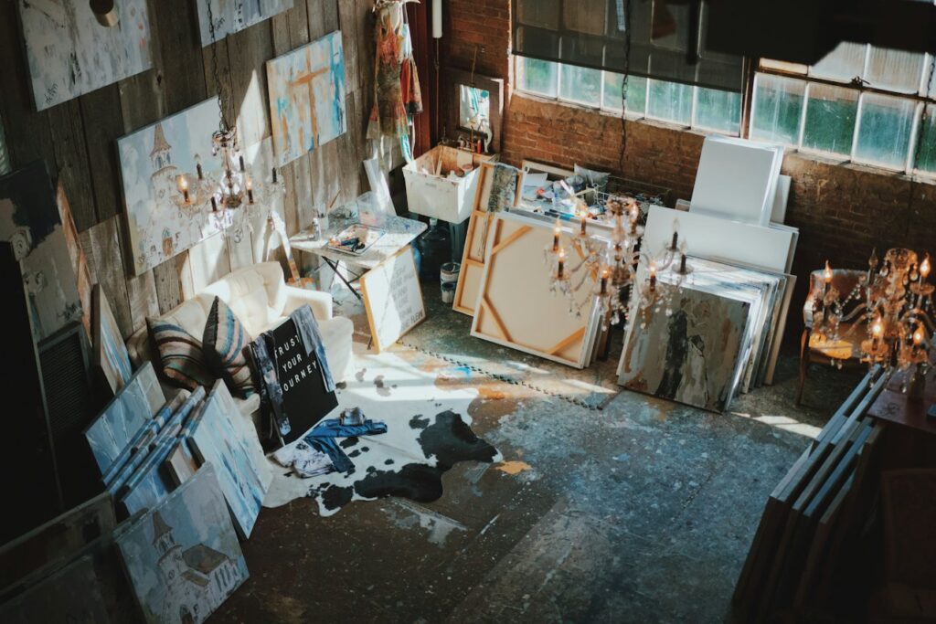 Canvases stacked and hung around a busy painting studio, for applicants meeting the Slade School of Fine Art portfolio requirements