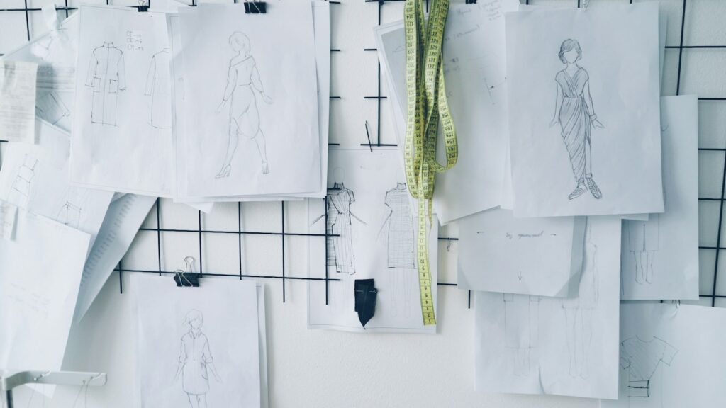 Sketches and notes pinned on a grid board, for applicants working out how to prepare a portfolio for art school in the UK