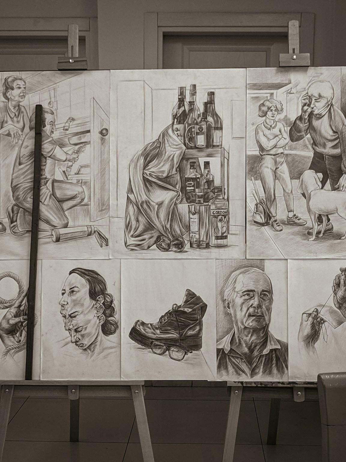 A student portfolio of pencil and charcoal drawings from observation, pinned to boards on easels