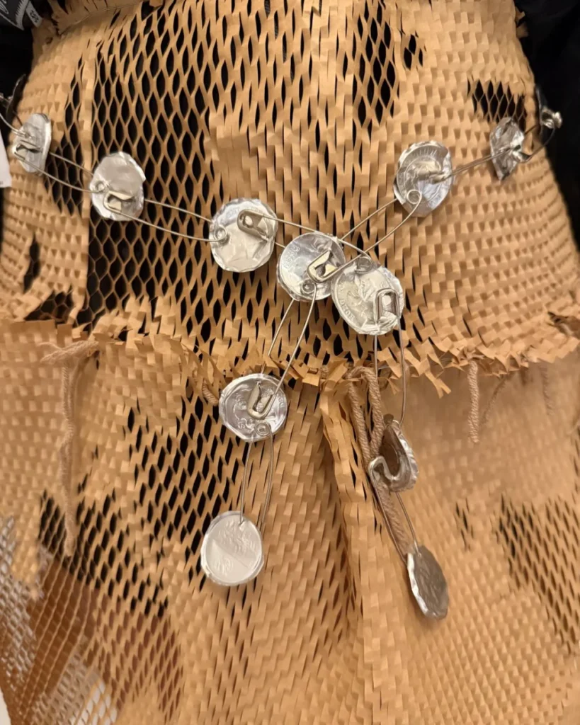Detail of a honeycomb paper skirt with silver discs